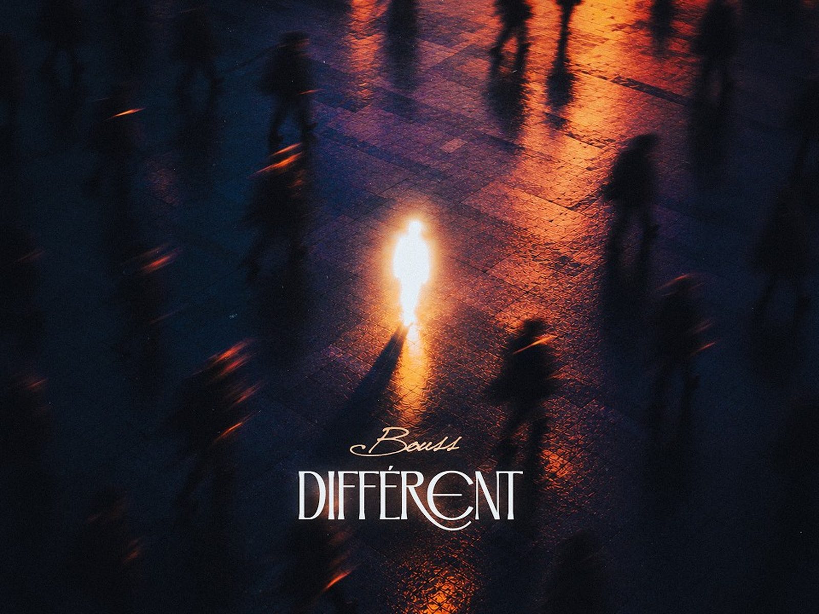 Bouss Different Lyrics Video Copertina 2026 Copertina del singolo Différent di Bouss: una figura luminosa in mezzo a sagome sfocate di notte